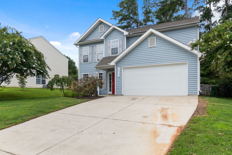 Front view of a house with a driveway in a residential neighbourhood